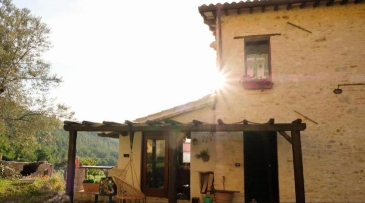 A renovated building in Umbria, well-lit by natural light, perfect for moments of relaxation.
