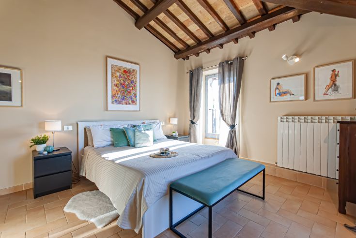 A well-lit, comfortable room featuring cozy beds and a simple style.