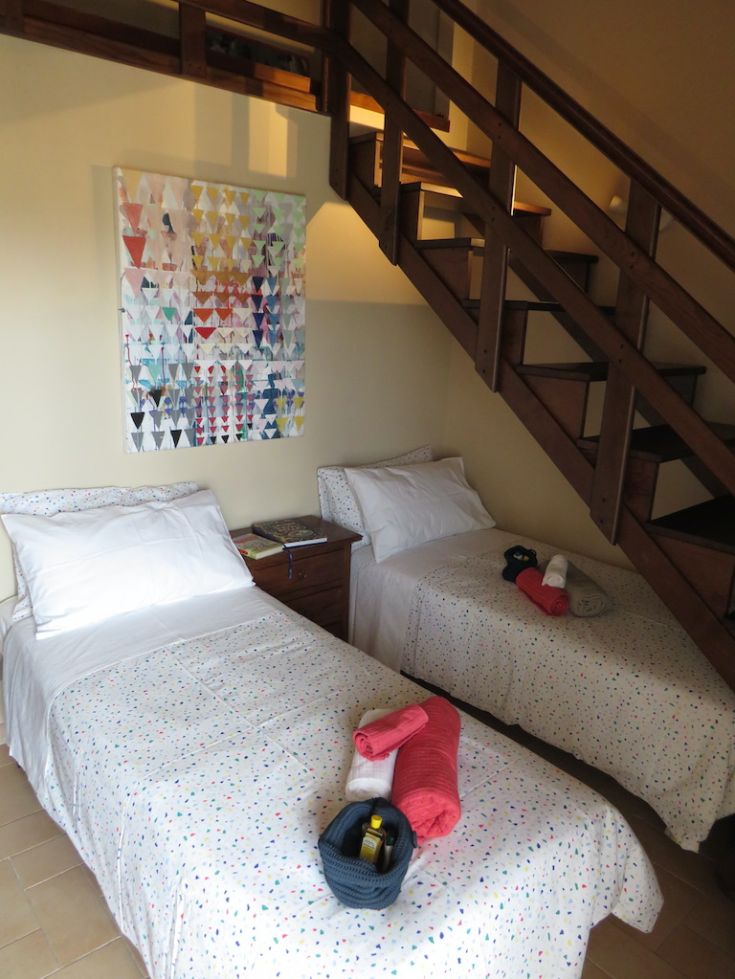 Comfortable room with single beds, decorated in warm tones and simple decor.