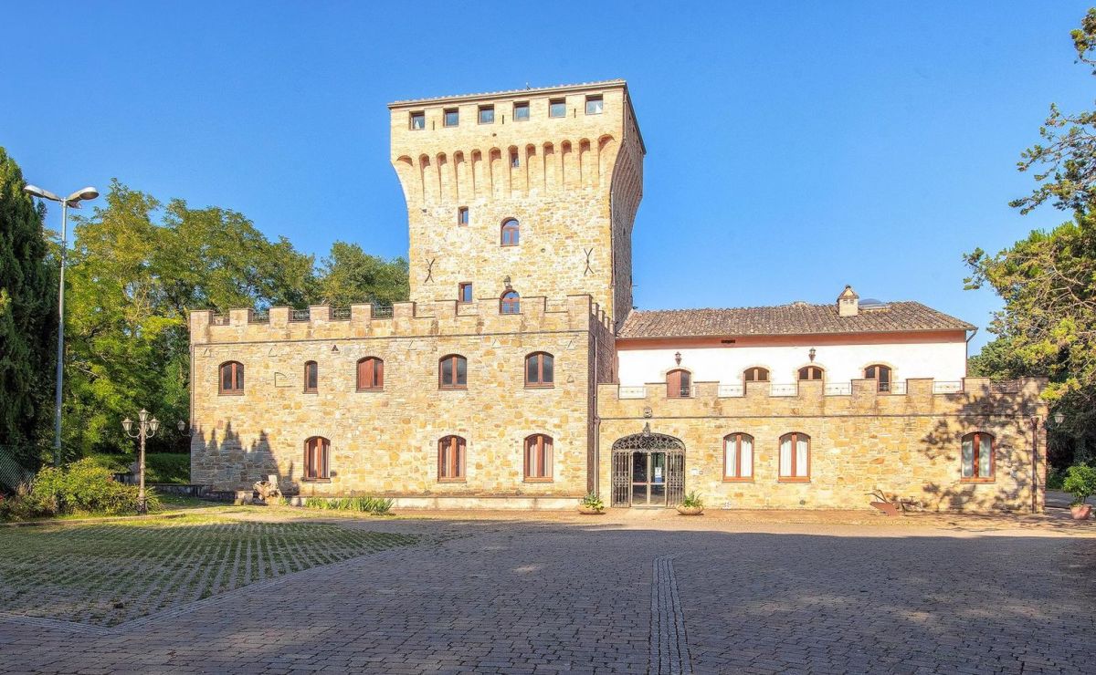 A historic building surrounded by greenery, located in a quiet area popular among tourists for its serene atmosphere.