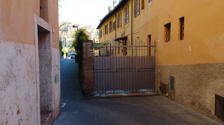 A peaceful pathway leading to a garden, nestled in the tranquility of the city.