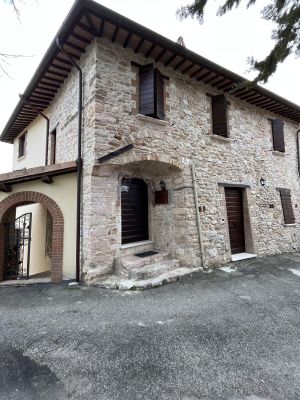 Stone building with a simple entrance and rustic details, surrounded by a natural setting.