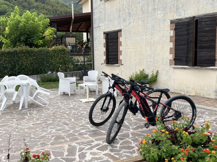 Interior of a palace, furnished with simplicity, surrounded by green spaces. Bicycles available for exploration.