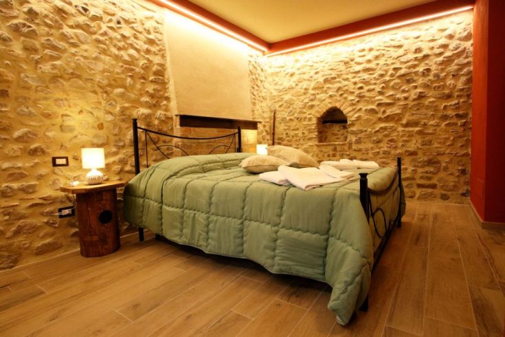 Ambiente tranquillo caratterizzato da pareti in pietra e elementi rustici, ideale per momenti di riposo.