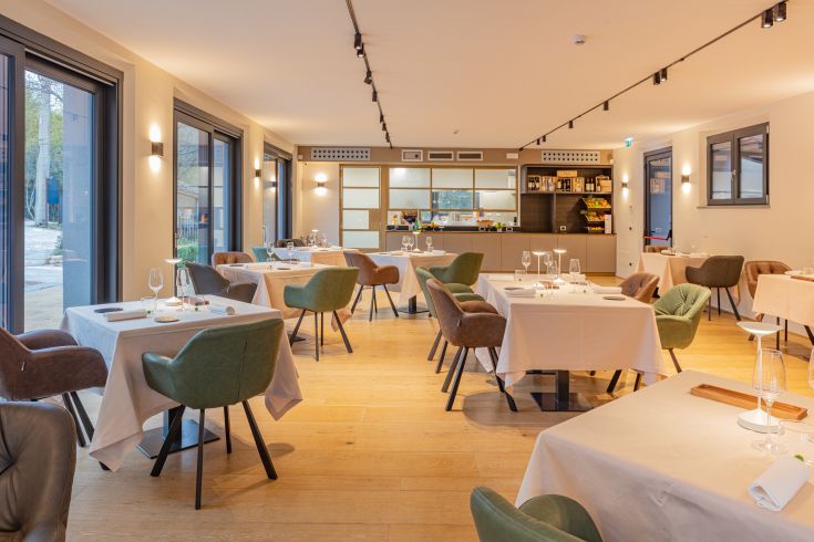 Ein gemütliches Restaurant mit ordentlich gedeckten Tischen und sanfter Beleuchtung.