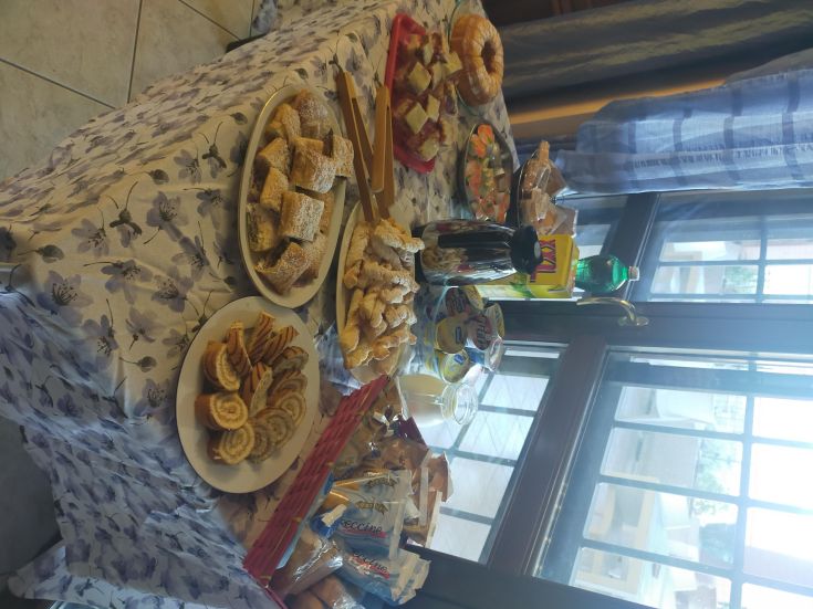 Breakfast with a selection of pastries and drinks served in a cozy setting.