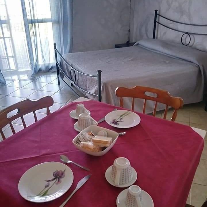 Spacious B&B room with a set table and beds. Perfect for a relaxing stay.