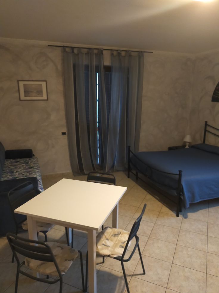 Cozy space with beds and a table, perfect for relaxing moments and peaceful stays.