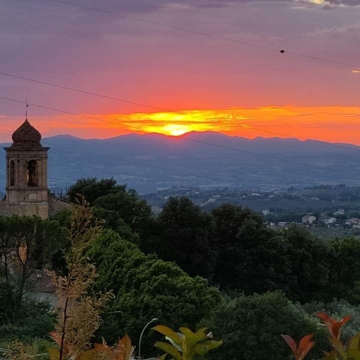 Sunset over the valley with a church in the foreground enhancing the scene.
