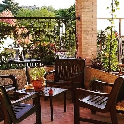 A cozy outdoor relaxation area surrounded by greenery.