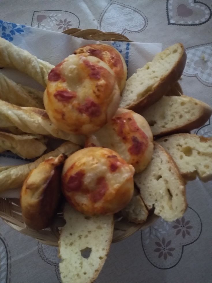 Simple crunchy bites and breadsticks served in a basket, perfect for a light snack.