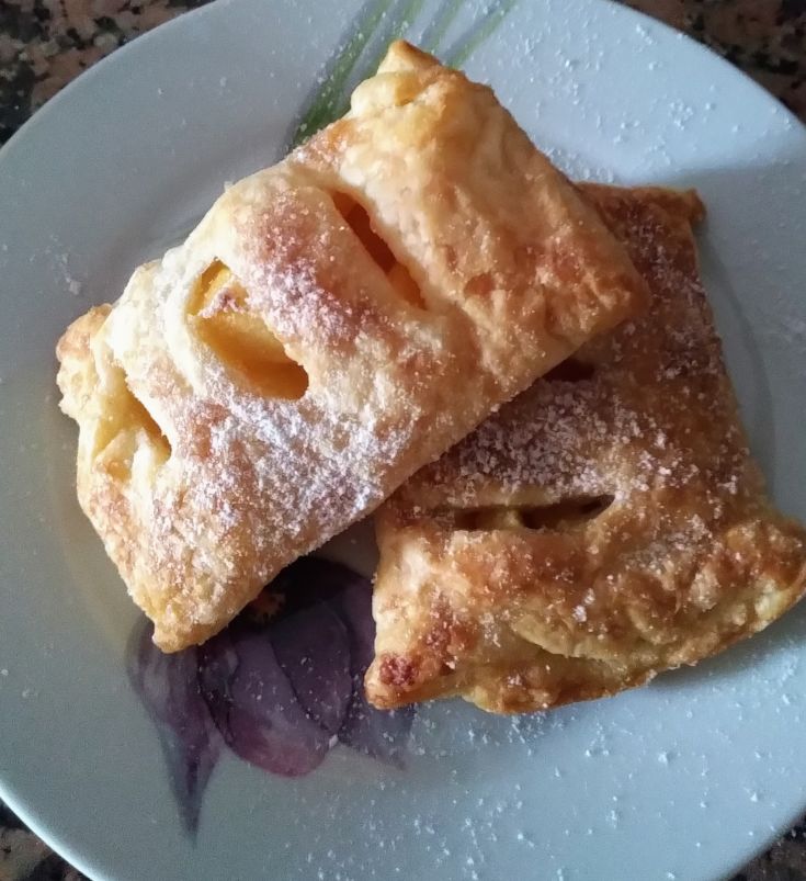 Sweet sfogliatelle with powdered sugar, perfect for a snack. They feature a delicious crispy layer.