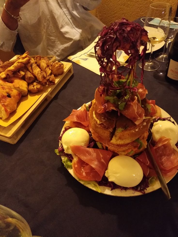 A mixed plate of cured meats, eggs, and vegetables, perfect for a hearty meal.