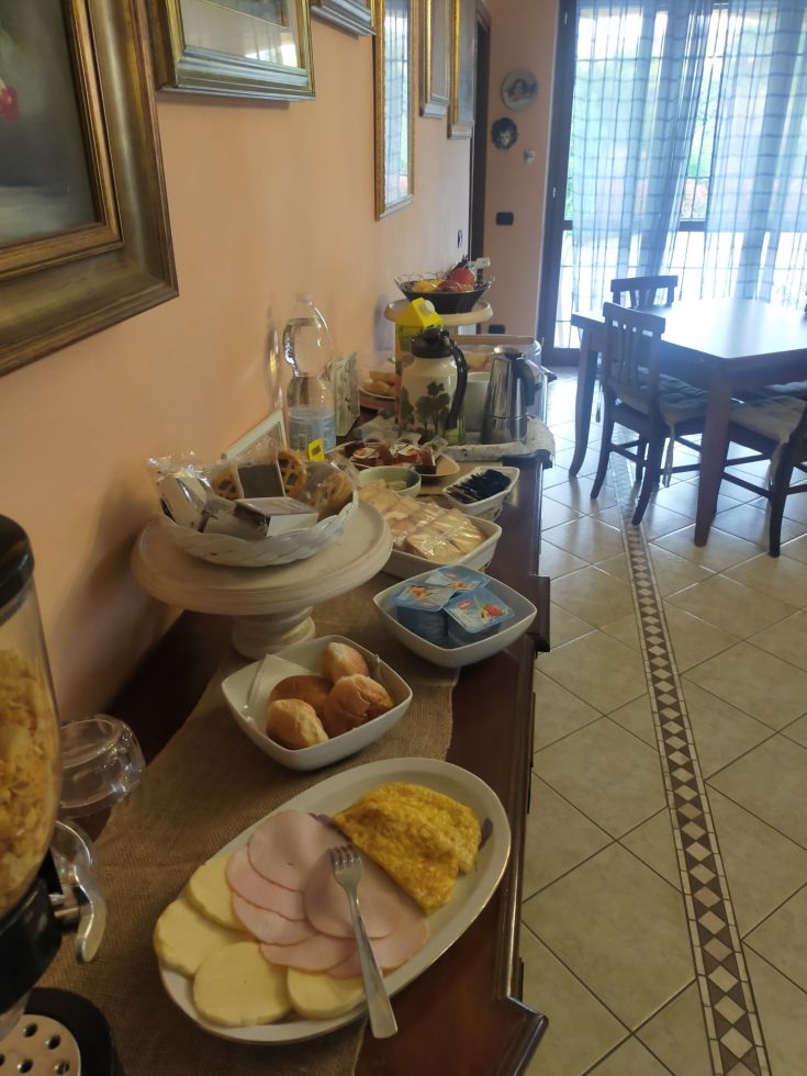 A hearty breakfast in a cozy family setting, featuring an array of fresh and homemade foods.