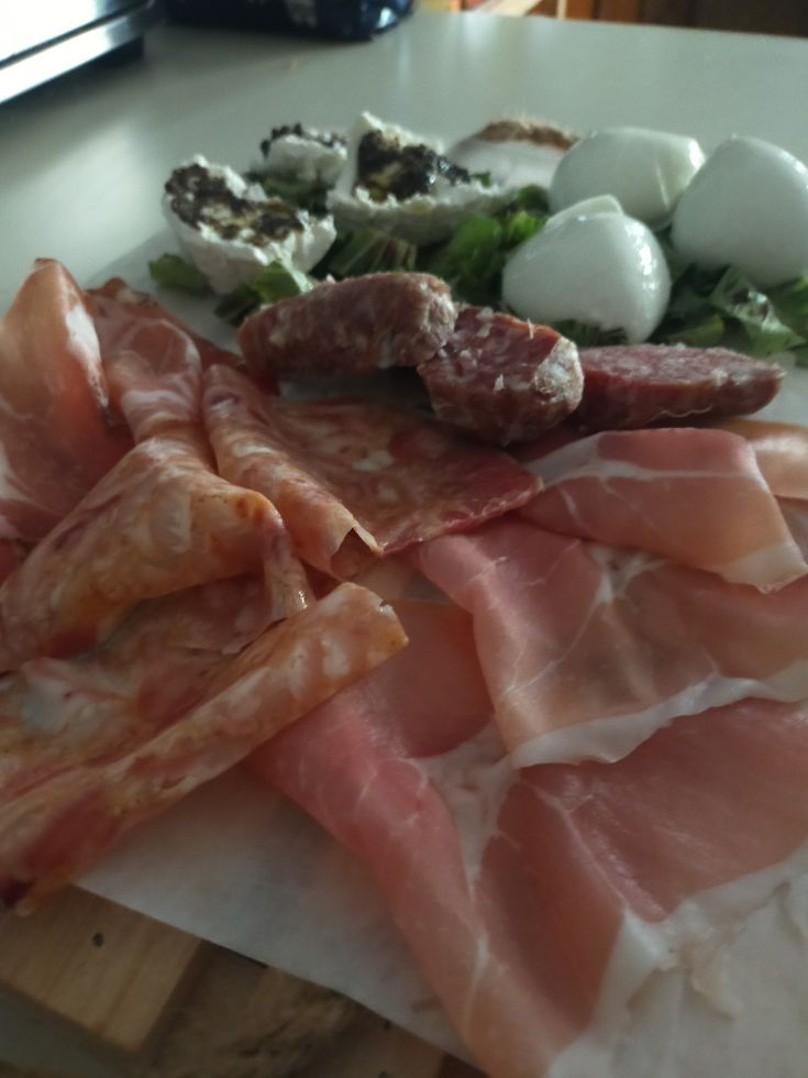 A platter of assorted cured meats and cheeses, perfect for a social gathering.