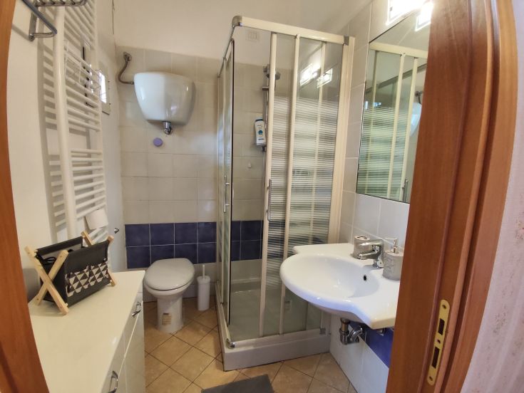 A contemporary bathroom featuring a shower, sink, and toilet. Bright and functional space.