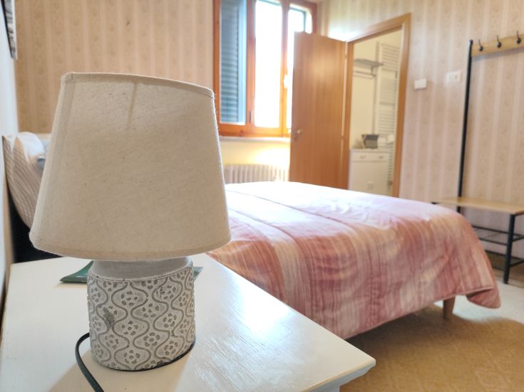 A lamp illuminates a simple room featuring modern design elements.