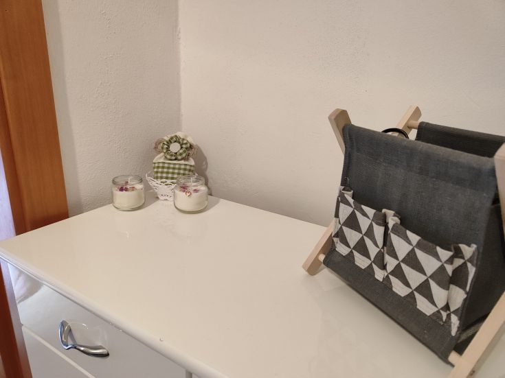 A desk adorned with candles and decorations in a chic yet simple environment.