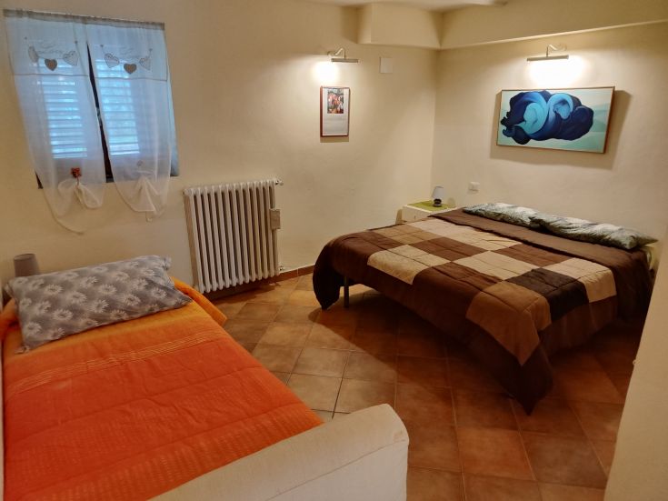 A cozy room with simple furniture and beds, perfect for moments of rest and relaxation.