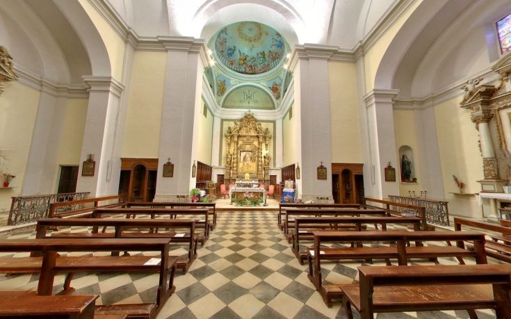 Interior of a church featuring simple architecture and understated decorations.