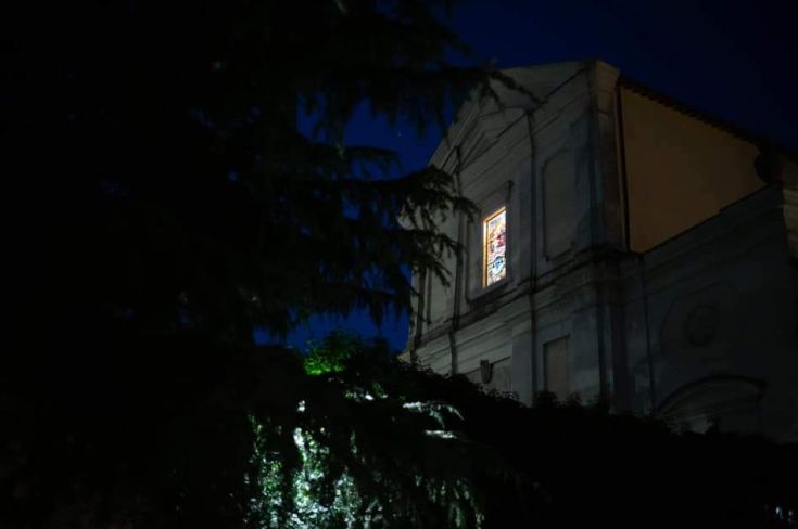 A serene and enchanting evening view of a illuminated Cistercian monastery.