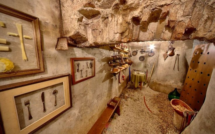 Interior of a building with rustic elements, featuring vintage kitchen utensils that create a warm atmosphere.