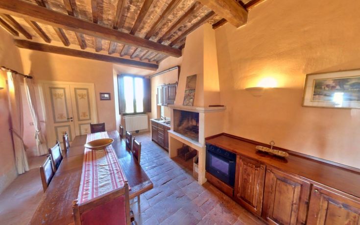The kitchen of Country House Monastero le Grazie, showcasing a simple and cozy atmosphere.