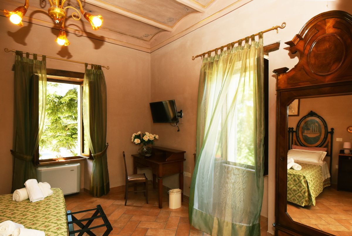 Cozy guesthouse room in a farmhouse, offering valley views and simple, functional decor.