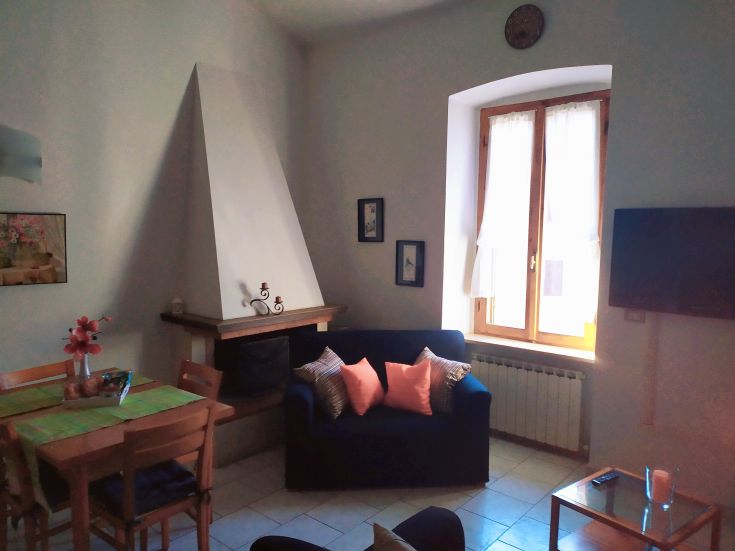 Bright and elegant living room with a comfy sofa and table, ideal for peaceful and social moments.