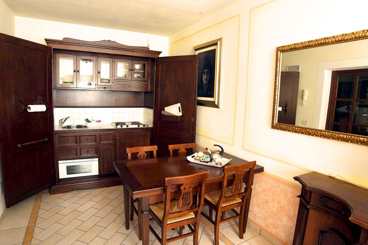 Tastefully furnished kitchen with wooden elements and a dining table for shared meals in a holiday home.