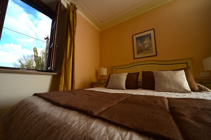 Simple and comfortable room at Residenze Luncinaia, overlooking a tranquil setting.