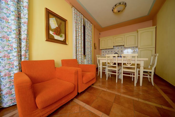 Interior of a vacation home, simple and cozy, with colorful furnishings and a functional kitchen.