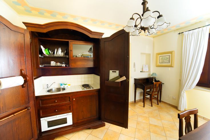 A warm and functional kitchen with light wood cabinets and modern appliances, perfect for family moments.
