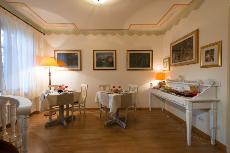 Spacious dining room with well-arranged tables and simple decorations.