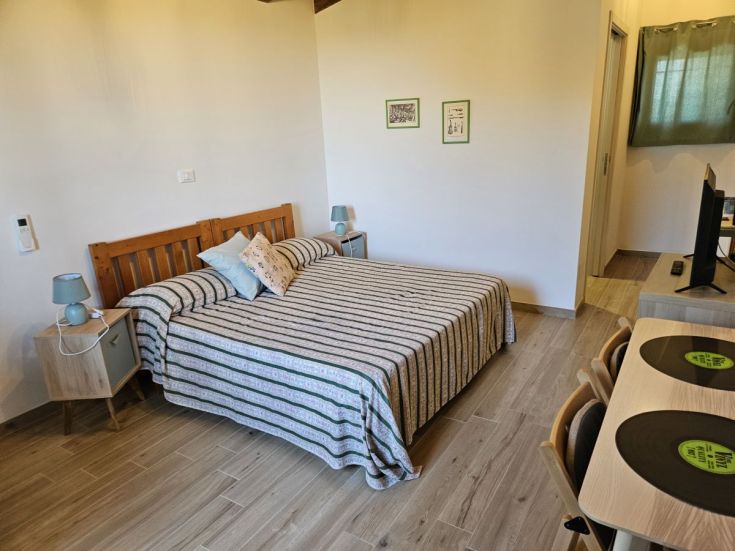 Schlichte und komfortable Zimmer mit einem Doppelbett und einer kleinen Entspannungsgelegenheit. Ideal für einen ruhigen Aufenthalt.