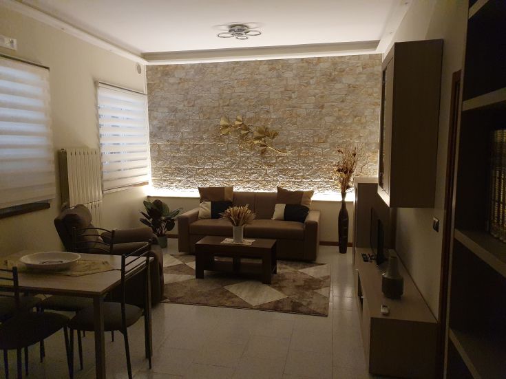 Cozy living room with warm light and simple furniture. A perfect space for daily relaxation.