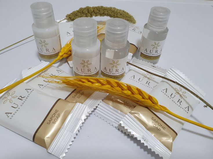 AURA beauty products displayed on a decorated surface with soap and natural elements.