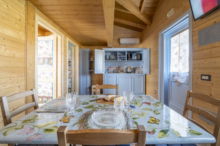 Salle à manger spacieuse avec des meubles en bois et des décorations florales, idéale pour des repas conviviaux.