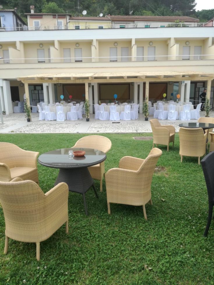 Exterior of Hotel Miralago, equipped for events with stylish tables and chairs.