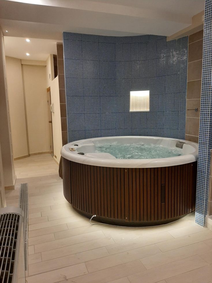 A wellness space featuring a hot tub, a peaceful corner to relax.