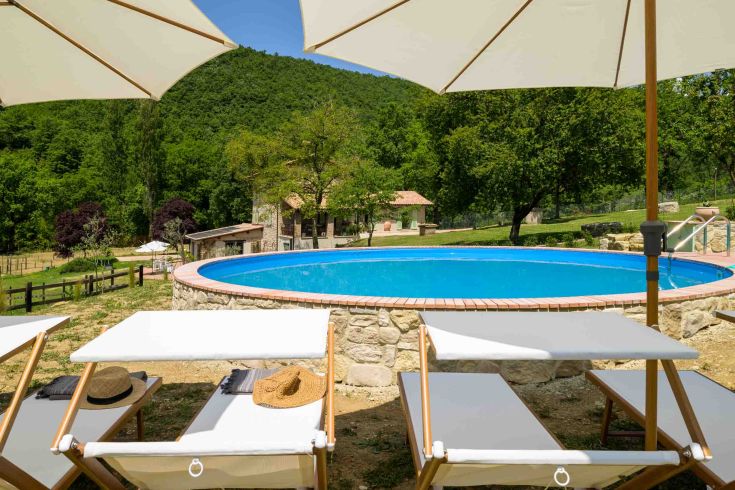 Relax by the pool surrounded by the tranquility of the Umbrian nature.