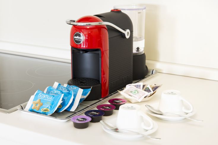 Une machine à café rouge avec des accessoires pour une pause café agréable.