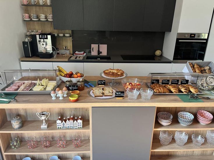 A variety of breakfast dishes, including cold cuts, cheeses, and pastries, for a delightful start to the day.