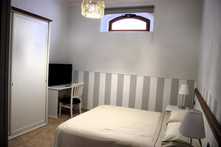 Espace confortable avec un lit double, une télévision et un bureau. Idéal pour un séjour paisible.