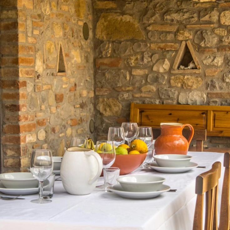A well-laid table for an outdoor lunch in a simple and comfortable setting.