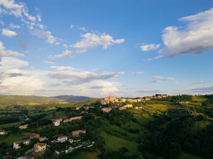 Un paesaggio che mostra colline morbide e piccoli borghi, caratteristici dell'Umbria.