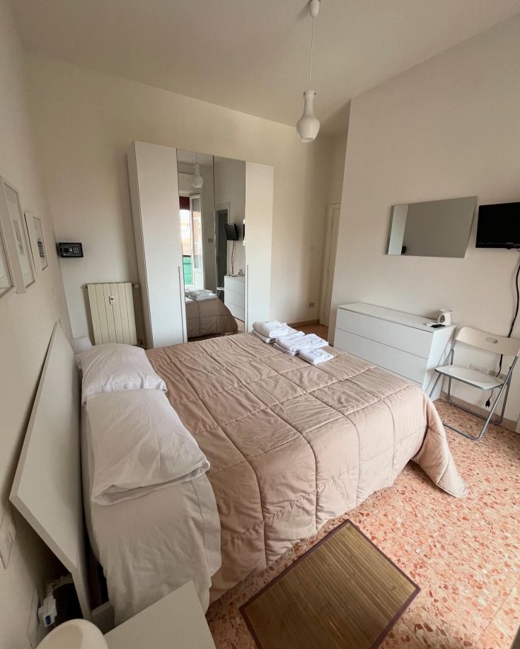Contemporary and comfortable room, simply furnished in neutral tones with attention to details.