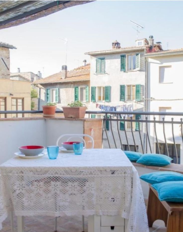 Ein möblierter Balkon mit Tisch und Geschirr, ideal für einen Moment der Entspannung im Freien.