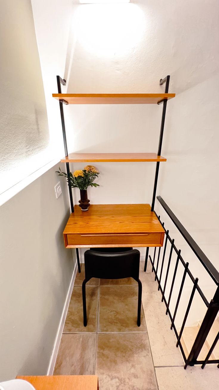 Ein einfacher Holztisch mit einer grünen Pflanze, ideal zum Lernen oder Arbeiten.