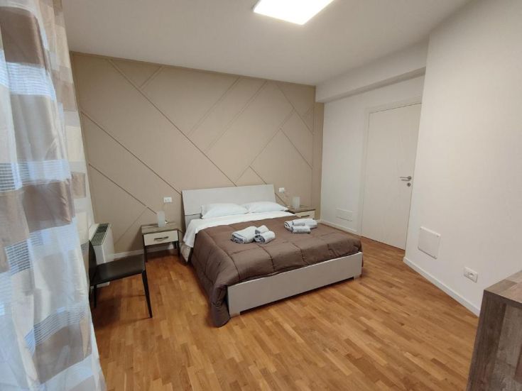 Spazio accogliente con un letto matrimoniale e mobili semplici e funzionali. Ottima illuminazione naturale.